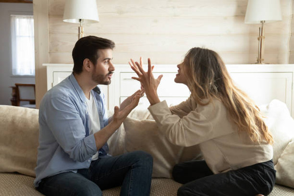 Emotional annoyed stressed couple arguing at home stock photo