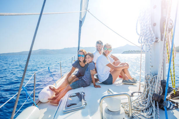 Family with adorable kids resting on yacht stock photo