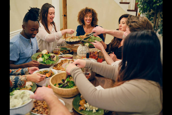 Friends Celebrating Thanksgiving Dinner Together stock photo