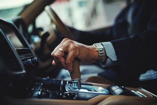 Young man and his car change gear