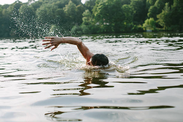 The Alpha's Little Witch man swimming